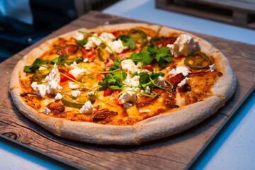 Fresh Rustic Pizza on a wooden board 