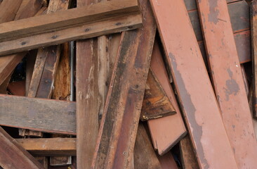 Closeup pile of damaged plank wood dumped on the floor during repairing work, high angle view 