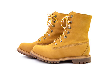 Pair of short yellow suede boots isolated on white background. Fashion and shopping concept