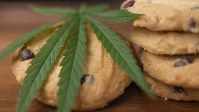 Cookies with marijuana leaf on table. Concept of cooking with cannabis herb