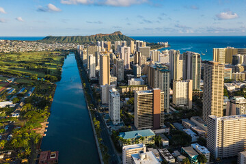Waikiki skyscrapers and Diamond Head Mountain at sunset. Tall buildings by Ala Wai Canal, Hawaii