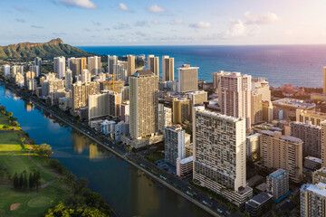Fototapeta na wymiar Tall buildings at Waikiki Beach and Wai Canal in Honolulu, Hawaii. Light effect applied