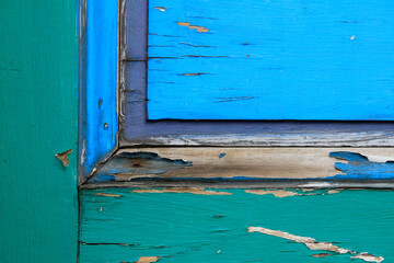 old wooden door with colorful peeling paint
