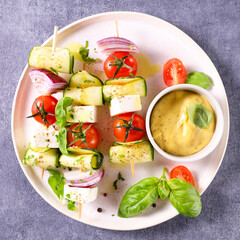 vegetarian skewer with courgette,  tomato,  feta and sauce