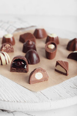 Tasty chocolate candies on board, closeup