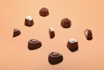 Tasty chocolate candies on color background