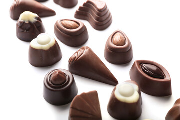 Tasty chocolate candies on white background