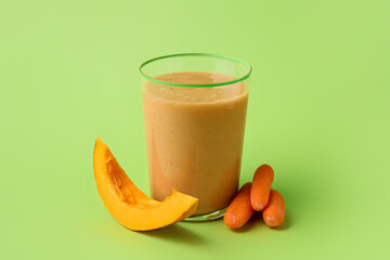Glass of healthy smoothie with vegetables on color background