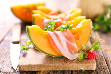melon slices with ham on board