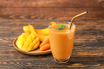 Glass of healthy smoothie and ingredients on wooden background
