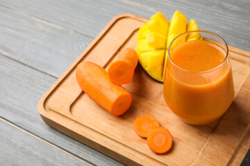 Glass of healthy smoothie and ingredients on wooden background