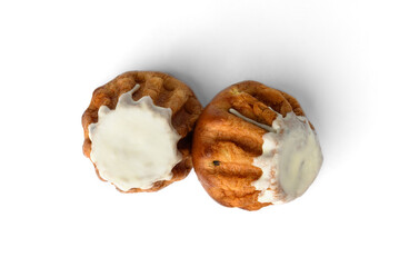 Sweet Rum Baba cake with powdered sugar glaze isolated on white background.