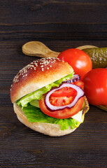 Cheeseburger isolated on a wooden background. Hamburger with cheese. Burger isolated. Tasty Dinner.Copy space