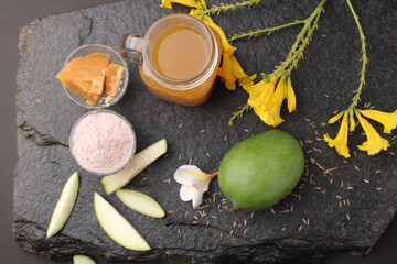 Raw Mango juice - Aam Panna or Panha in a transparent glass with whole green fruit,