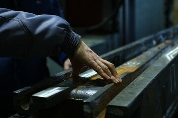 Worker testing a railway in a factory