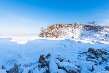 Olkhon island winter landscape. View of the mountains and frozen Lake Baikal on a clear day