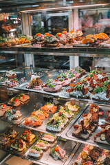 Copenhagen food market restaurant display of open faced sandwiches, local delicacy. Danish food in Denmark travel.
