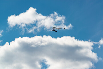 Flying wing in the sky with clouds.
