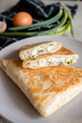 a plate of rolls with cheese and herbs