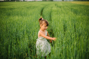 girl playing in the field. summer time. childhood.
