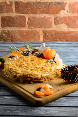 Traditional napoleon cake decorated with tangerines and christmas cookies. Christmas or New Year...