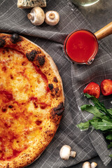 Top view on neopolitan fresh baked margherita pizza on the grey background