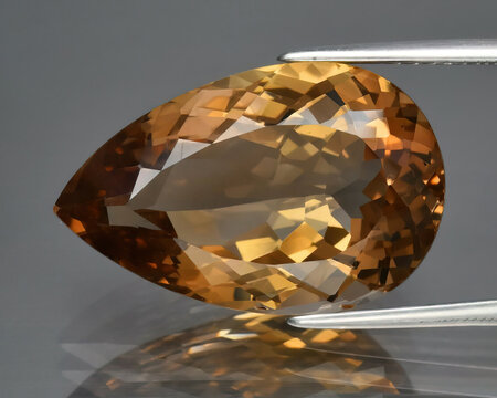 Natural gemstone orange imperial topaz on gray background