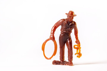 Vintage toy brown cowboy isolated on white background