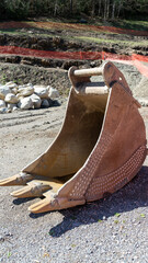 iron excavator shovel, arranged on the earth ground