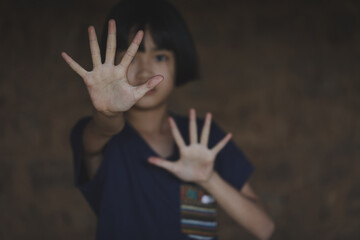Kid girl showing hand signaling to stop useful to campaign against violence and pain. Stop abusing...