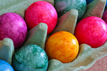 Easter colorful eggs are in a cardboard box.
