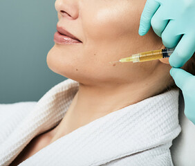 Beautiful woman while facial plasmolifting at cosmetology clinic. Lipofilling, plasma therapy for...