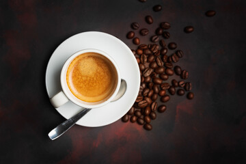 White cup of coffee and coffee bean on dark background. Copy space.view from above.