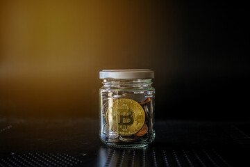 Gold bitcoin and money coin in glass bottle. Crypto currency and finance concept. 