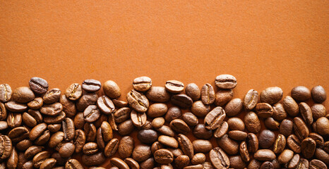 Roasted coffee beans on brown paper background 