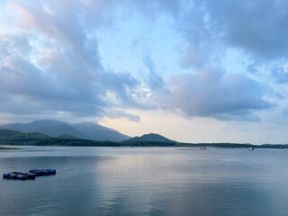 The atmosphere of the tent with a view of the surroundings and the mountains and there is a thin mist nearby and beautiful pine trees all around.