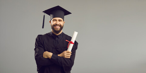 Portrait of a happy student in an academic dress and hat having a university or academy...