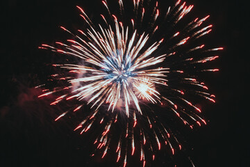 Festive salute or firecrackers on night sky. Explosions of fireworks and pyrotechnics in the sky.