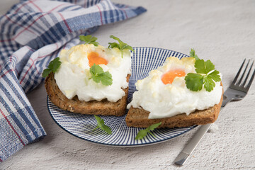 A diet dish of beaten and baked Orsini eggs on toast. Light background. French aristocrats ' breakfast