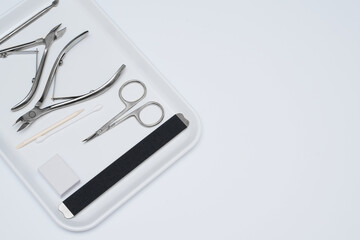 Set of manicure scissors, clipper, spatula, for nail care on a grey background. Professional pedicure equipment for teachers, beauty salons or home use. Manicure on self-isolation. . 