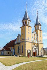 Fototapeta na wymiar TRZCIANA, POLAND - MARCH 31, 2021: Church and garden