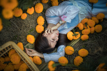 Obraz na płótnie Canvas Marigold Yellow flower and the artist girl.