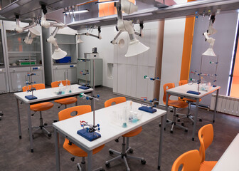 Fototapeta na wymiar Chemistry class at school. An empty, clean laboratory in a university college science classroom.