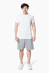 Man in white t-shirt and gray shorts full body