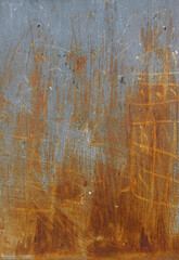 rusty iron surface of a vertical plank with orange and brown tones and handmade scratches