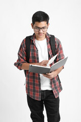 Education concept : Indian college student holding bag and reading book on white background