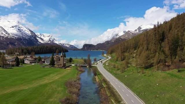 Dramatic aerial footage of lake Sils near Silvaplana in the Engadine valley in Canton Graubunden in the alps in Switzerland on a sunny summer day. 