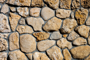 Decorative wall made of natural stone of various shapes and sizes. Interior background