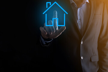 Real estate concept, businessman holding a house icon.House on Hand.Property insurance and security...