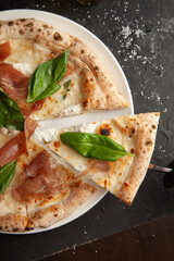 fresh italian pizza on black background